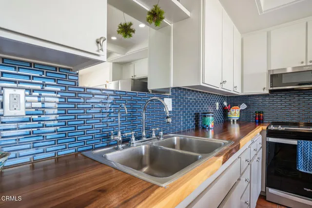 a kitchen with sink a cabinets and entryway