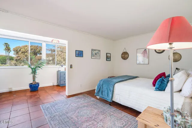 a bedroom with a bed and a couch