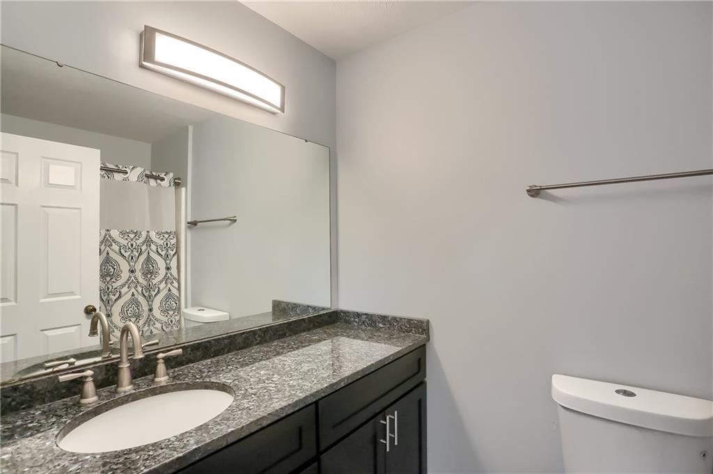 1075 Rural Ridge Drive Cheswick, PA 15024 - Photo 11 of 25 The en-suite bathroom features a granite topped vanity, tub/shower combo, stylish lighting and modern hardware.