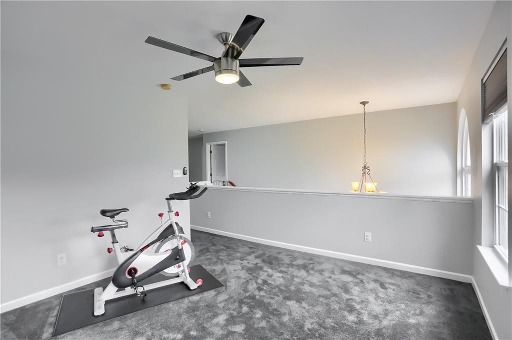 1075 Rural Ridge Drive Cheswick, PA 15024 - Photo 12 of 25 Ascend to the upper level loft with sun filled windows, plush carpet and a ceiling fan.