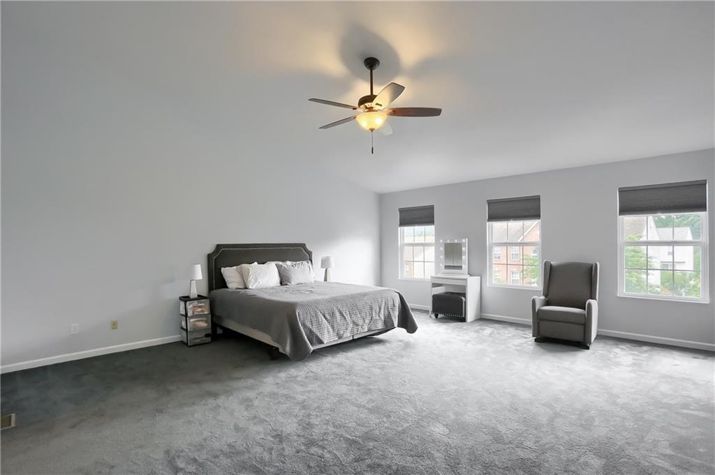1075 Rural Ridge Drive Cheswick, PA 15024 - Photo 13 of 25 The master suite is an expansive retreat with neutral tones, ceiling fan, 2 walk in closets and vivid windows.