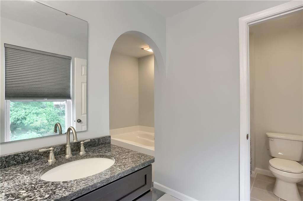 1075 Rural Ridge Drive Cheswick, PA 15024 - Photo 14 of 25 A granite topped dual sink vanity and new tile floor give this master bathroom a modern finish.
