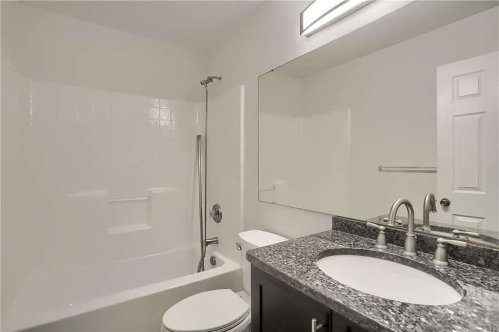 1075 Rural Ridge Drive Cheswick, PA 15024 - Photo 17 of 25 The shared hall bathroom features a tub/shower combo and a modern granite topped vanity.