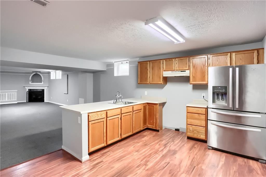 1075 Rural Ridge Drive Cheswick, PA 15024 - Photo 22 of 25 A full kitchen with updated tile floor is conveniently located in the lower level. This space provides all you need for it to become an in law suite.