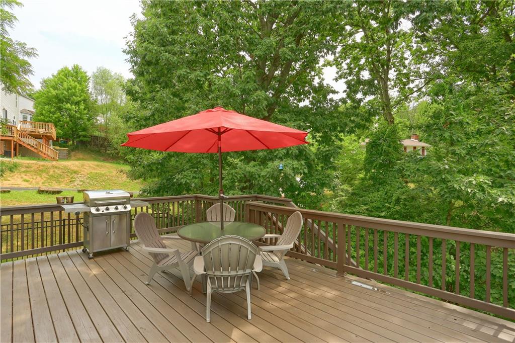 1075 Rural Ridge Drive Cheswick, PA 15024 - Photo 23 of 25 Off of the kitchen is access to the rear deck overlooking the mature back dropped yard. Enjoy an evening cocktail with friends and family on the private deck.