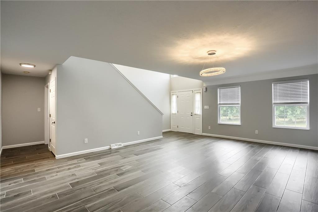 1075 Rural Ridge Drive Cheswick, PA 15024 - Photo 8 of 25 A dramatic two story foyer and front door with side lights flood the entryway with sunlight. Open to the generously sized dining room, vivid windows pour sunlight throughout the first level of this home.