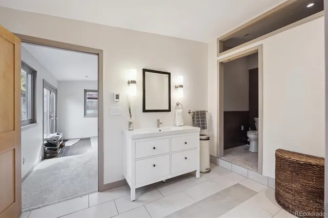 a spacious bathroom with a double vanity sink and a mirror