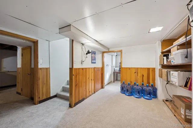 a view of a livingroom with furniture and a hallway