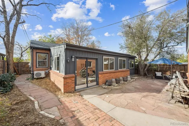 a patio with a table and chairs under an umbrella