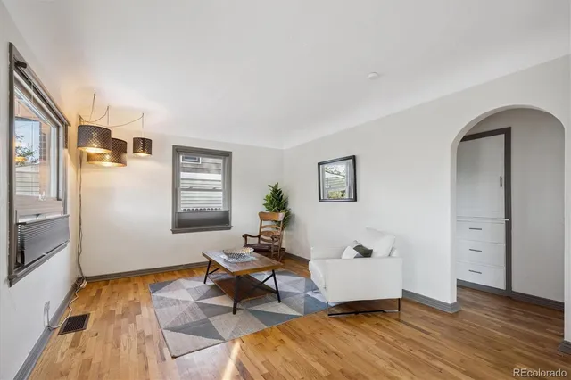 a living room with furniture and wooden floor