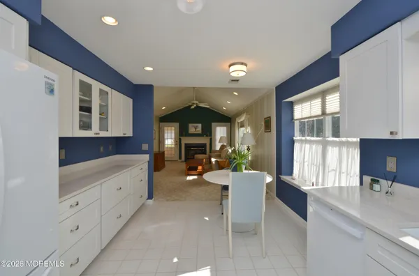 a dining room with furniture a rug and a large window