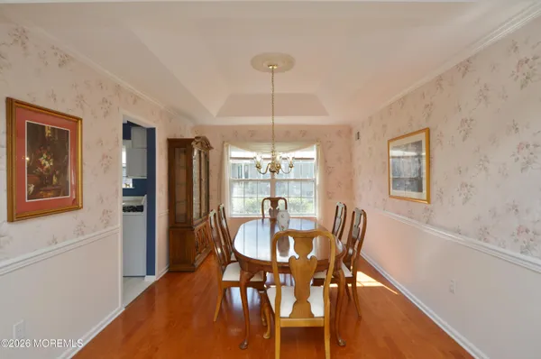a kitchen with stainless steel appliances kitchen island granite countertop a refrigerator a sink a stove with white cabinets