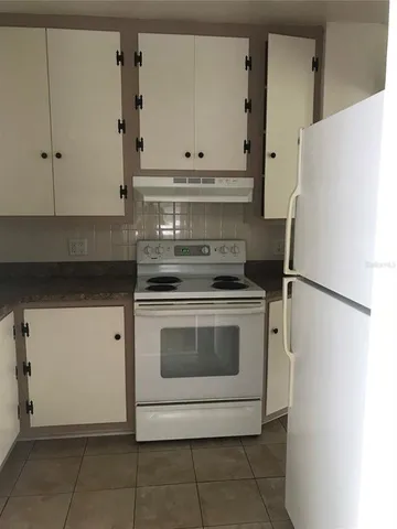 a kitchen with stainless steel appliances white cabinets and a stove