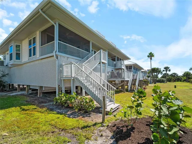 an aerial view of a house with swimming pool and mountains