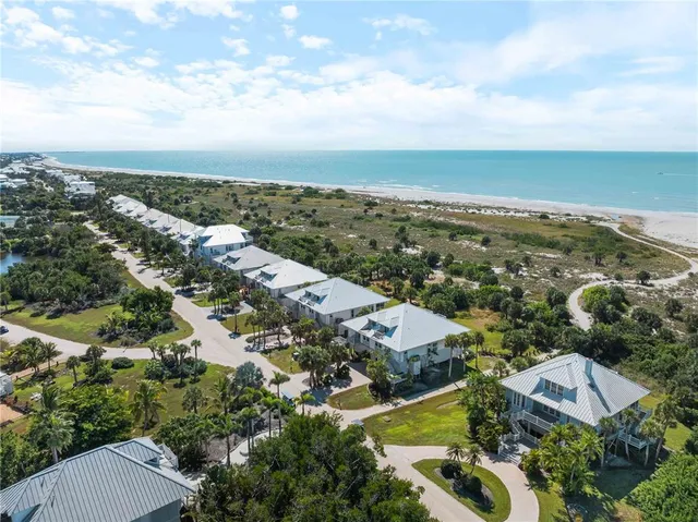 a kitchen with granite countertop white cabinets and stainless steel appliances