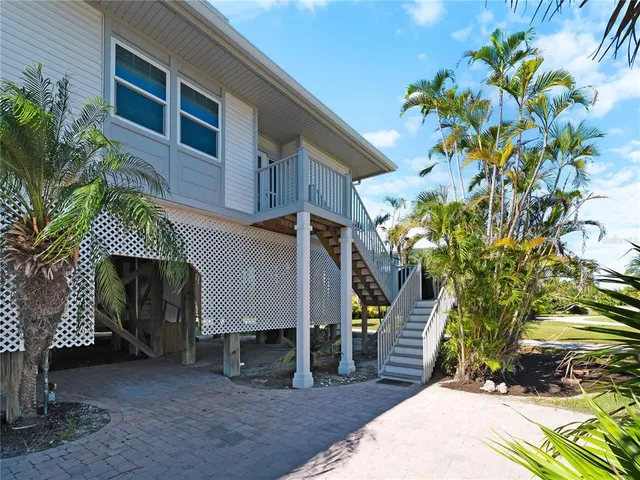 an aerial view of a house with big yard and large trees