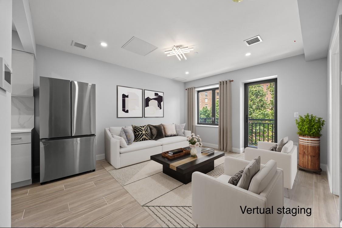 132-25 41st Avenue, Unit 5B Queens, NY 11355 - Photo 3 of 11 a living room with furniture and a large window