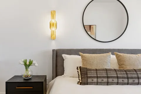a bedroom with a bed and a chair