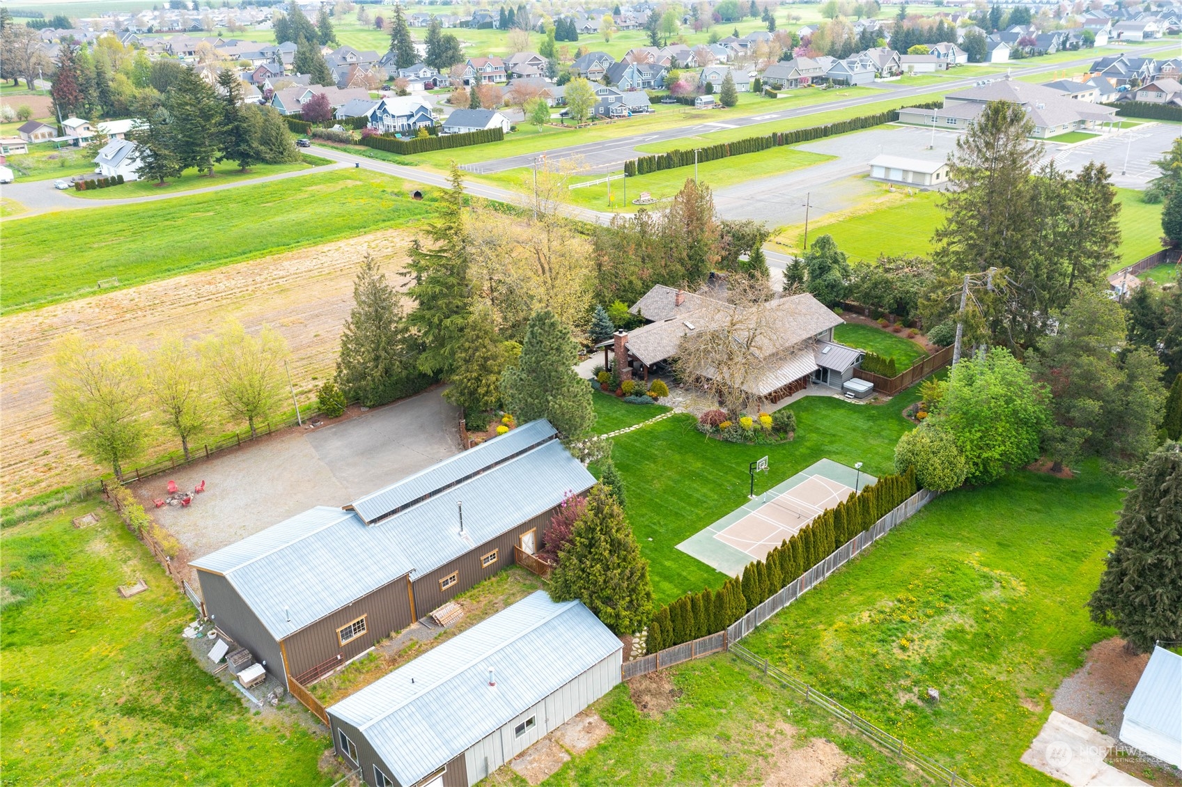 8629 Benson Road Lynden, WA 98264 - Photo 3 of 40 an aerial view of a house with a garden and swimming pool