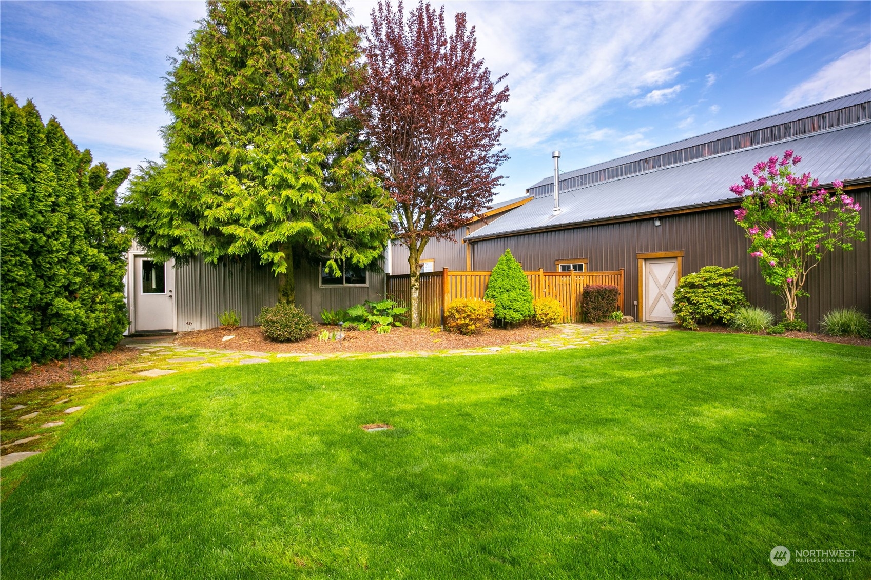 8629 Benson Road Lynden, WA 98264 - Photo 34 of 40 a view of a backyard with potted plants and large tree