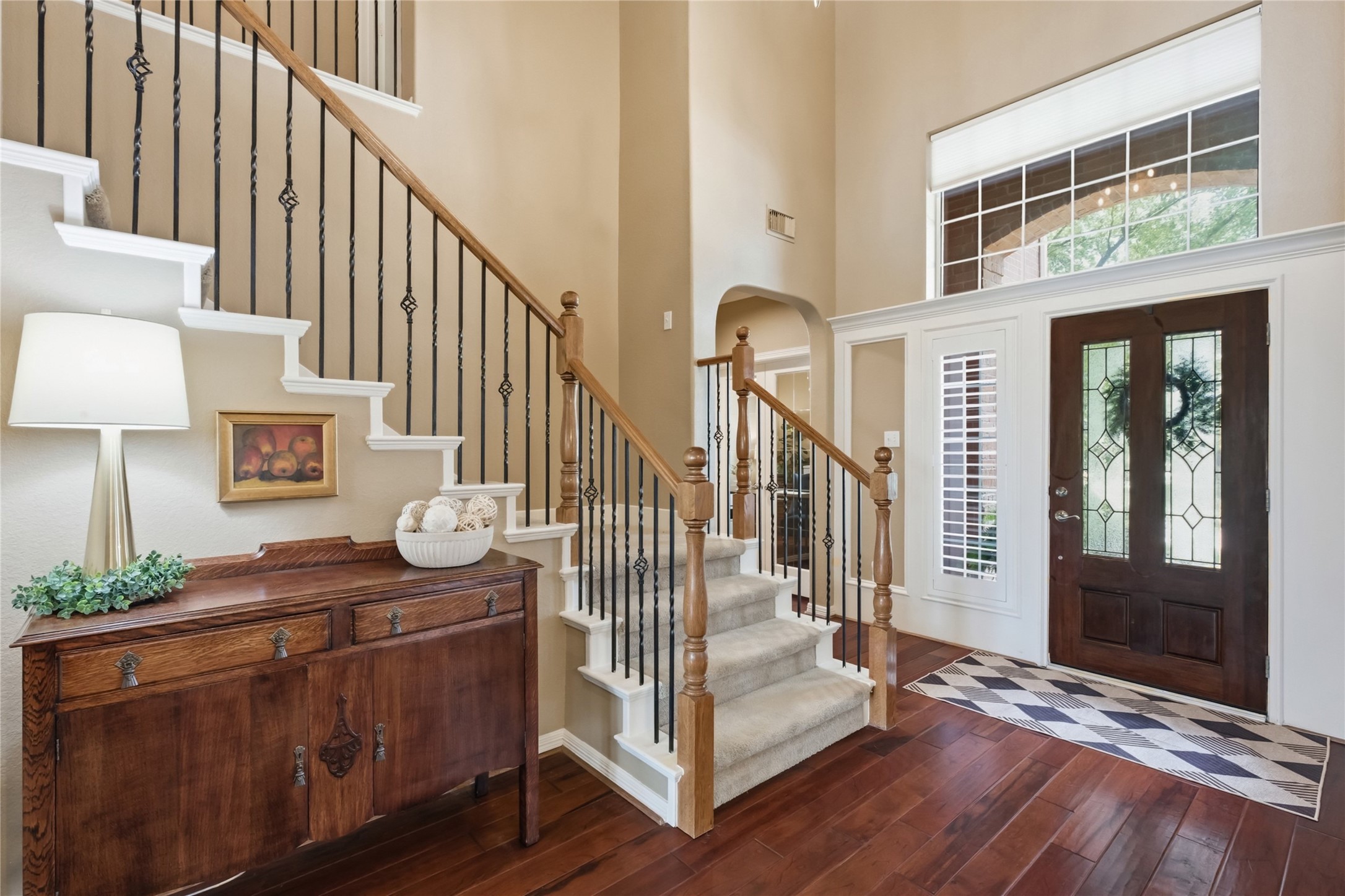 20722 Windrose Bend Drive Spring, TX 77379 - Photo 8 of 50 Step into this inviting entryway, where elegance meets functionality with a home office and half bath to the left, complemented by a stunning staircase with black iron spindles.