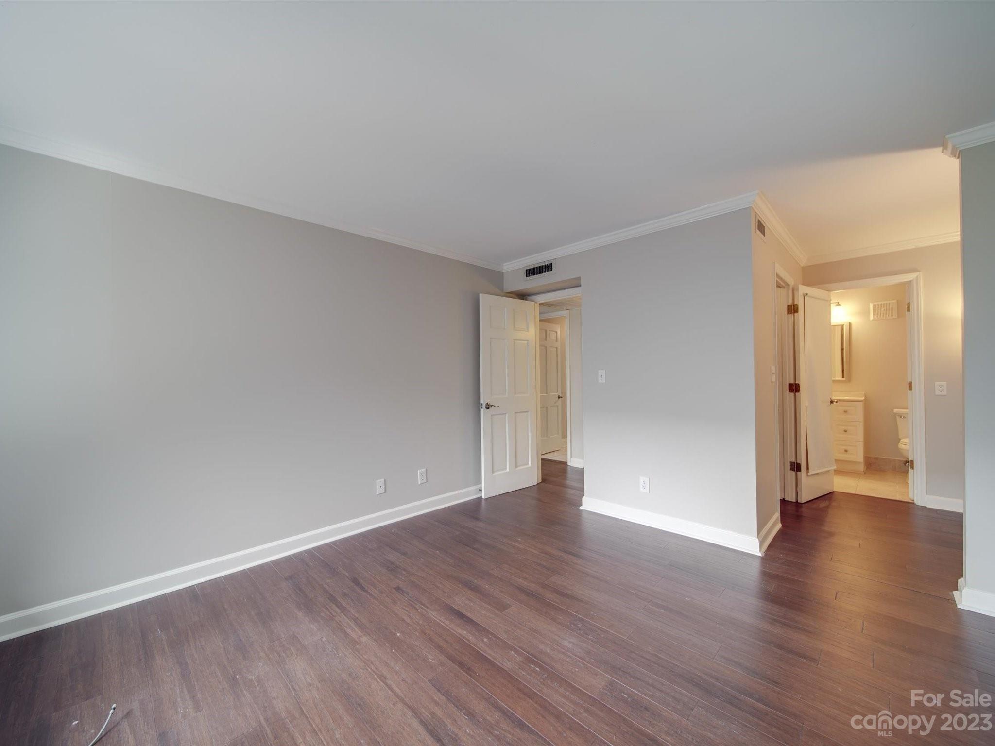 1323 Queens Road, Unit 402 Charlotte, NC 28207 - Photo 11 of 26 a view of an empty room with wooden floor