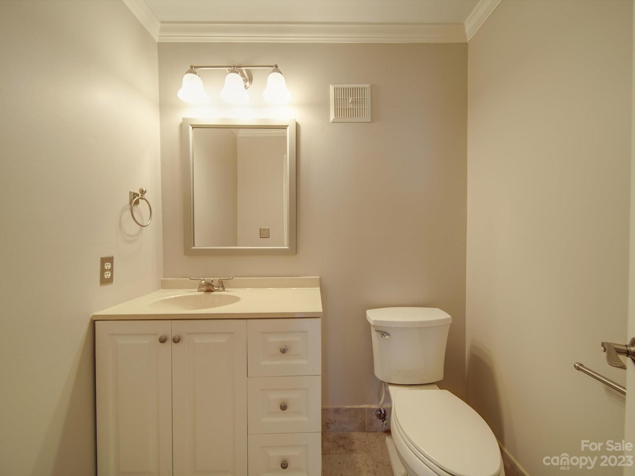 1323 Queens Road, Unit 402 Charlotte, NC 28207 - Photo 13 of 26 a bathroom with a toilet sink and mirror