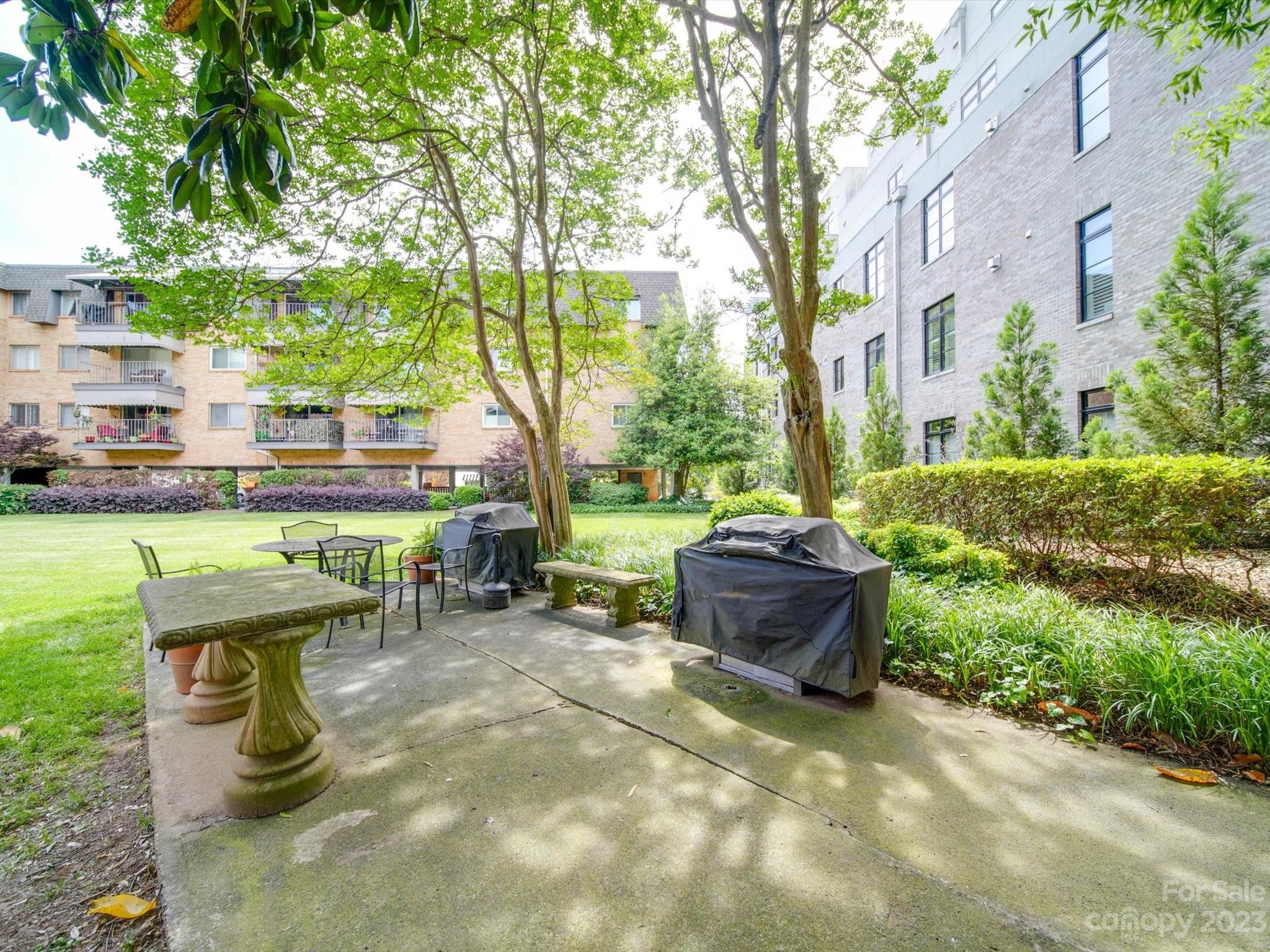 1323 Queens Road, Unit 402 Charlotte, NC 28207 - Photo 19 of 26 a view of a chairs and table in backyard of the house