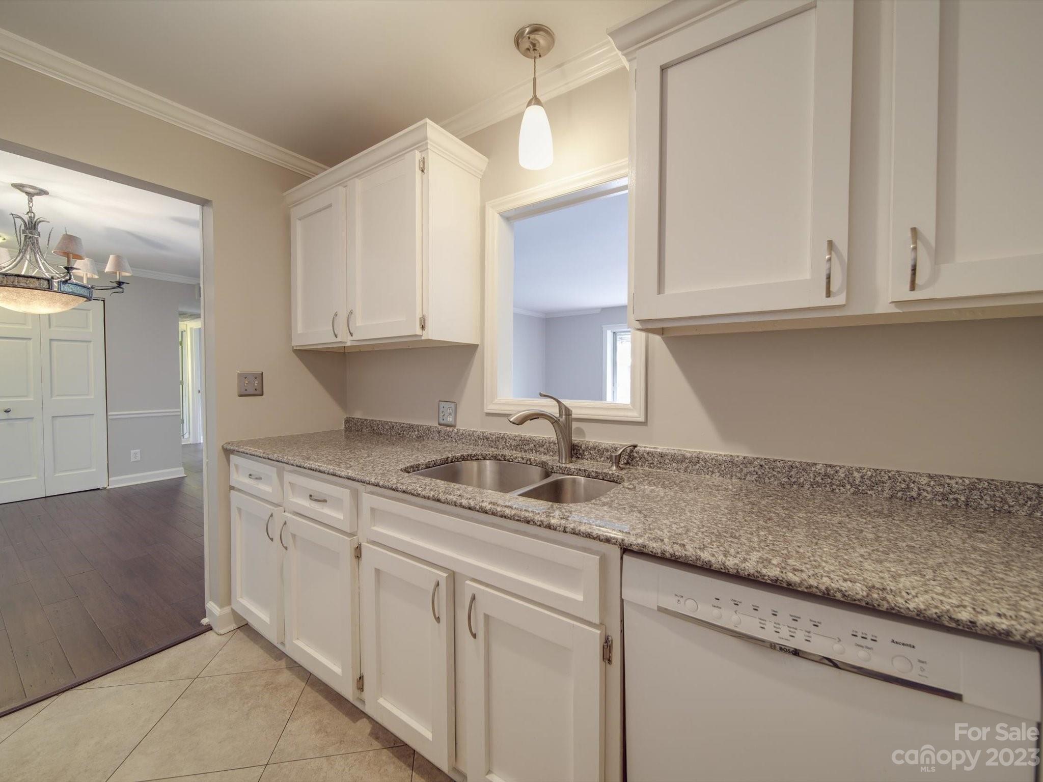 1323 Queens Road, Unit 402 Charlotte, NC 28207 - Photo 2 of 26 a kitchen with granite countertop white cabinets and a sink