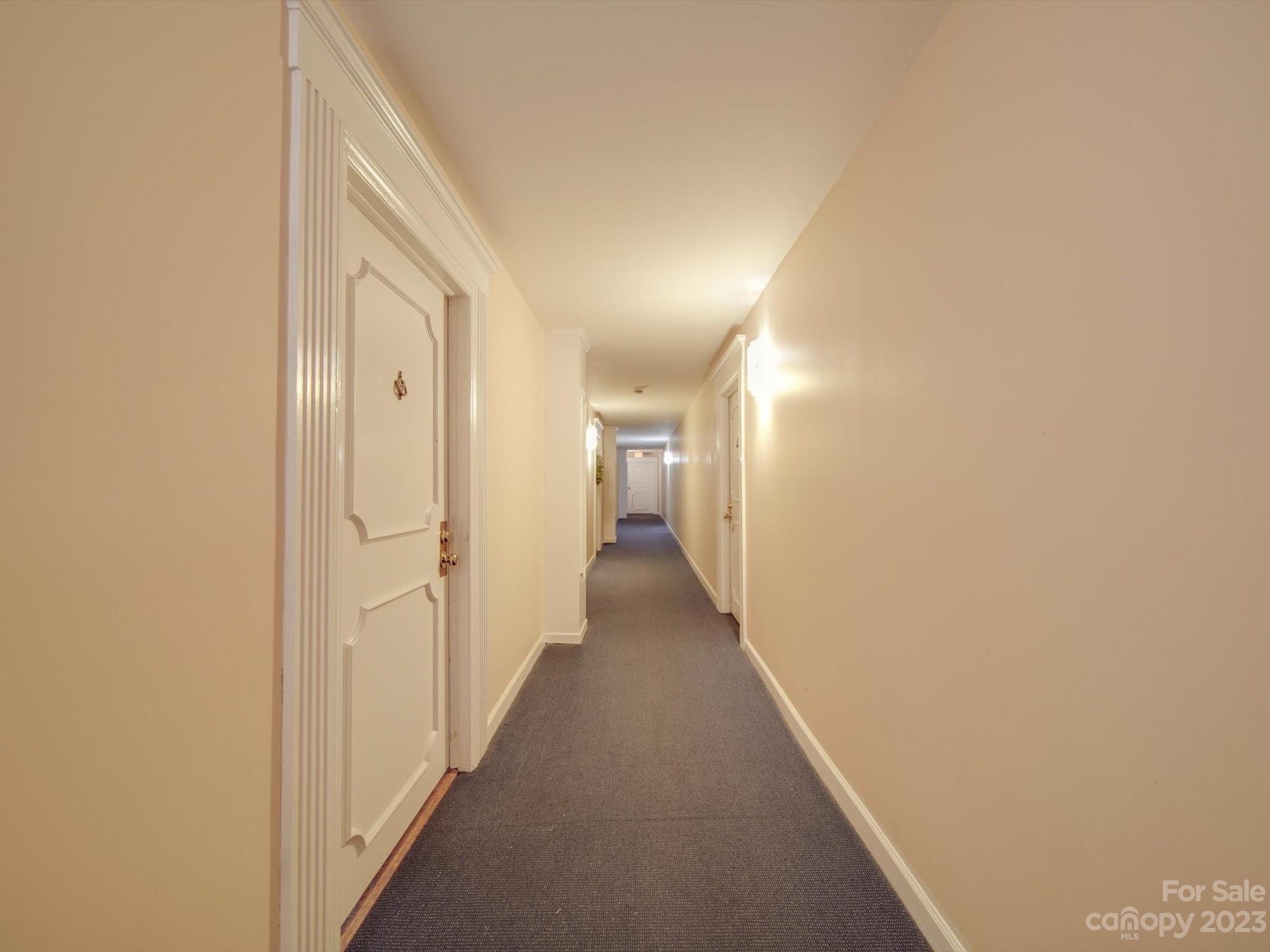 1323 Queens Road, Unit 402 Charlotte, NC 28207 - Photo 24 of 26 a view of a hallway with a white walls
