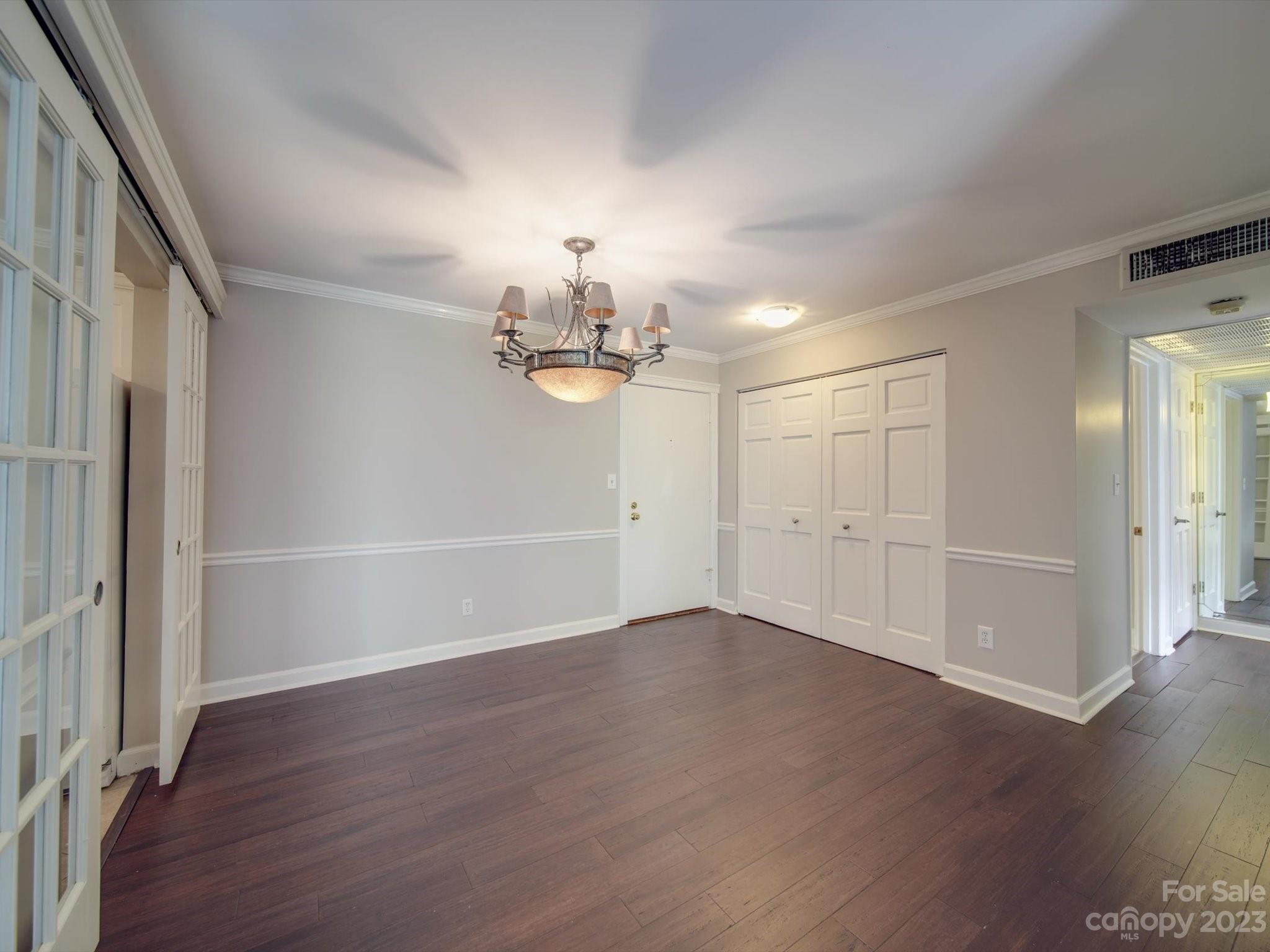 1323 Queens Road, Unit 402 Charlotte, NC 28207 - Photo 7 of 26 an empty room with wooden floor and windows
