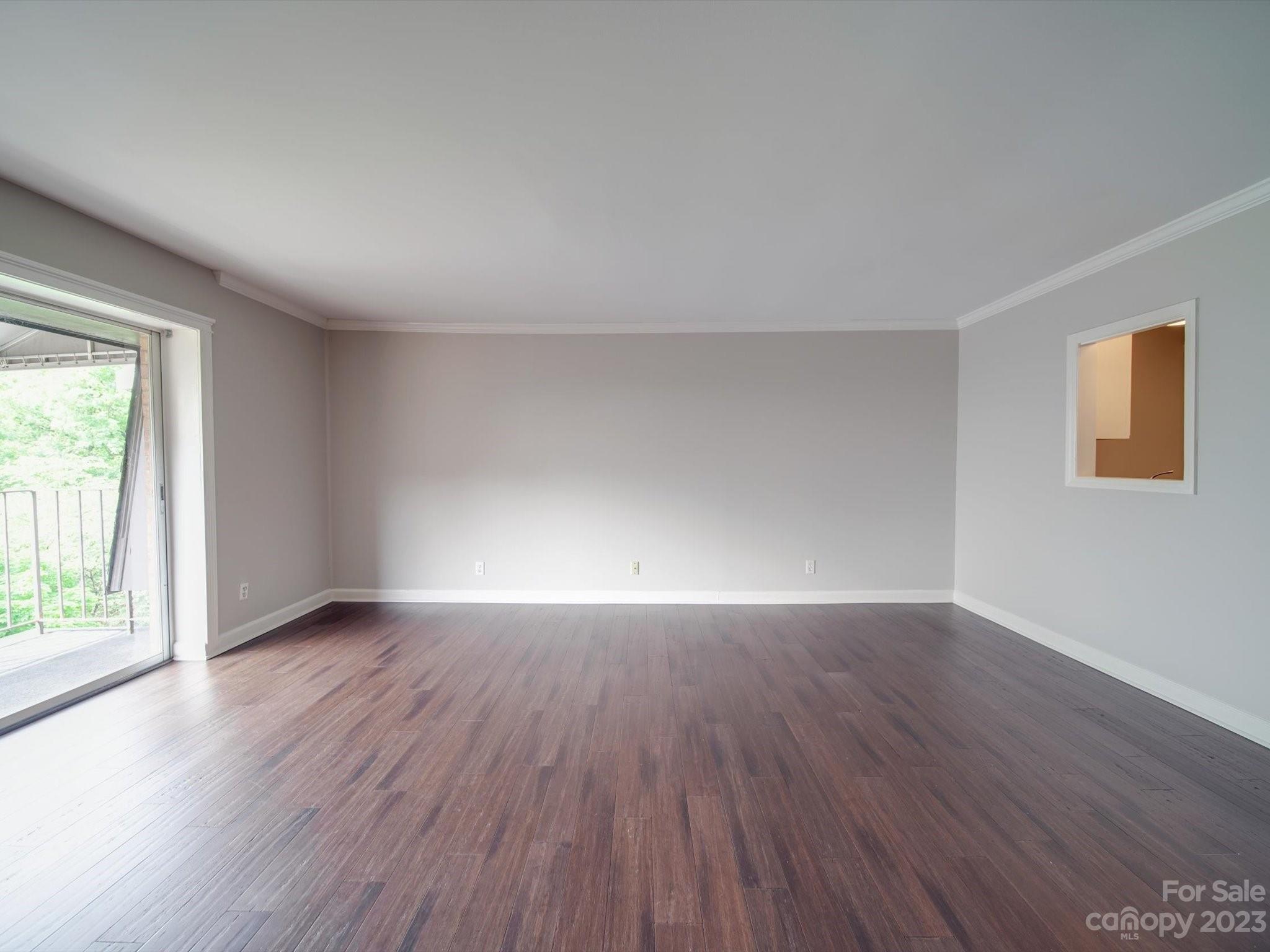 1323 Queens Road, Unit 402 Charlotte, NC 28207 - Photo 8 of 26 an empty room with wooden floor and windows
