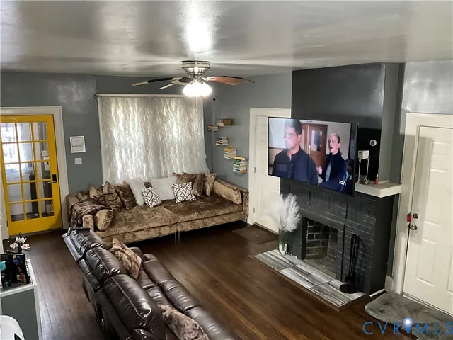 a living room with furniture fireplace and flat screen tv