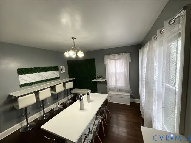 a view of a livingroom with furniture window and wooden floor