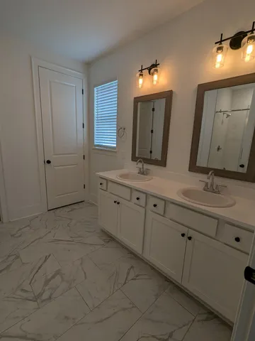 a bathroom with a double vanity sink mirror and