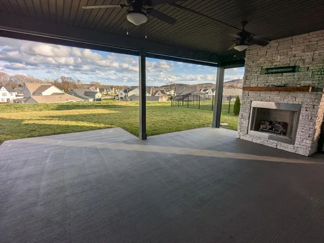 a view of an empty room with a fireplace and a window