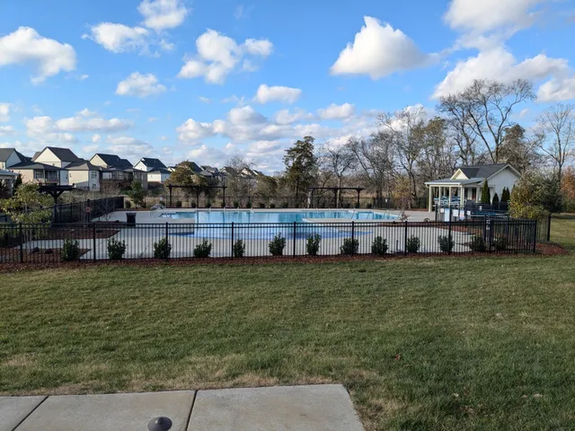 a view of outdoor space with playground and green space