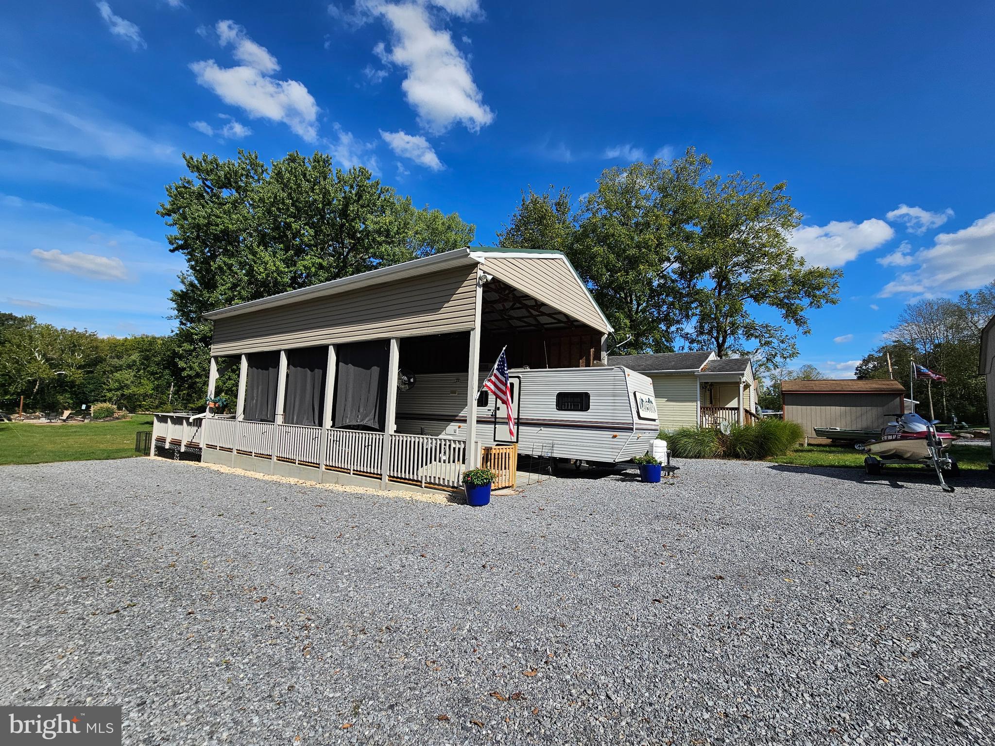 a white house covered with tall trees