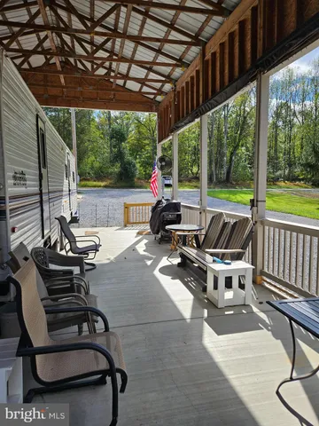 a living room with patio furniture and a floor to ceiling window