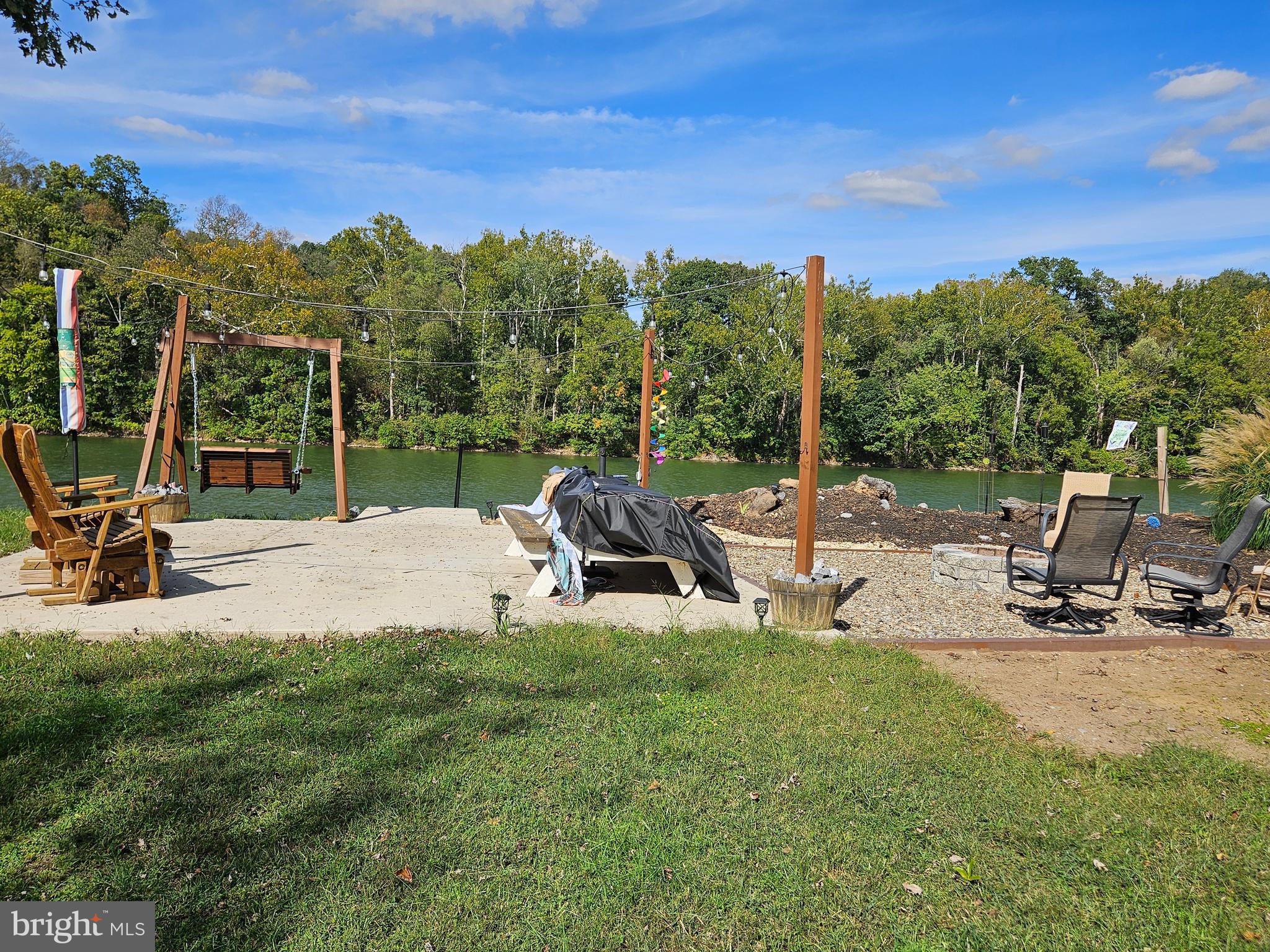 56 Boo Boo Boulevard Falling Waters, WV 25419 - Photo 3 of 48 a view of a swimming pool with a bench and trees in the background