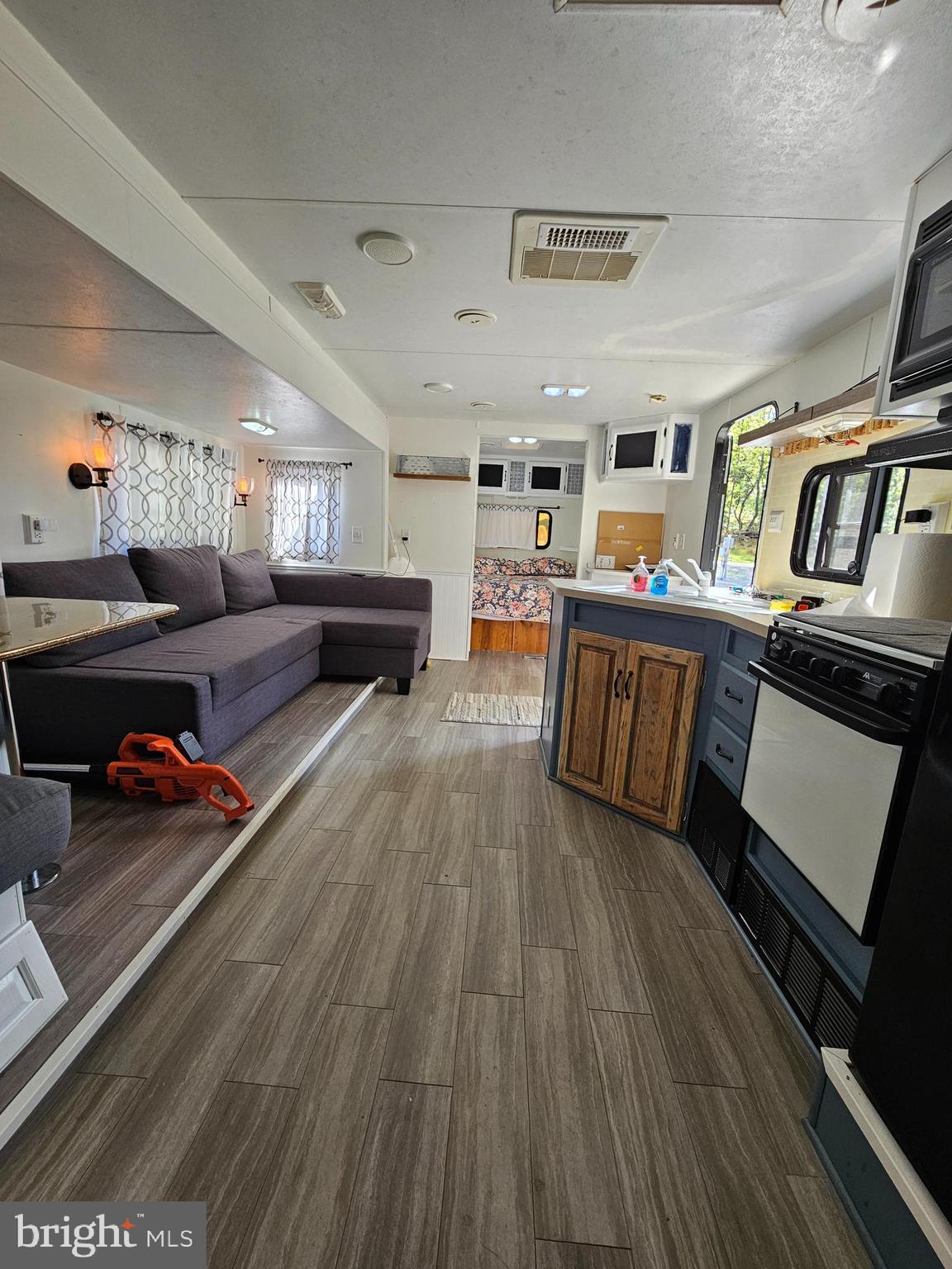 56 Boo Boo Boulevard Falling Waters, WV 25419 - Photo 32 of 48 a living room with furniture and a wooden floor