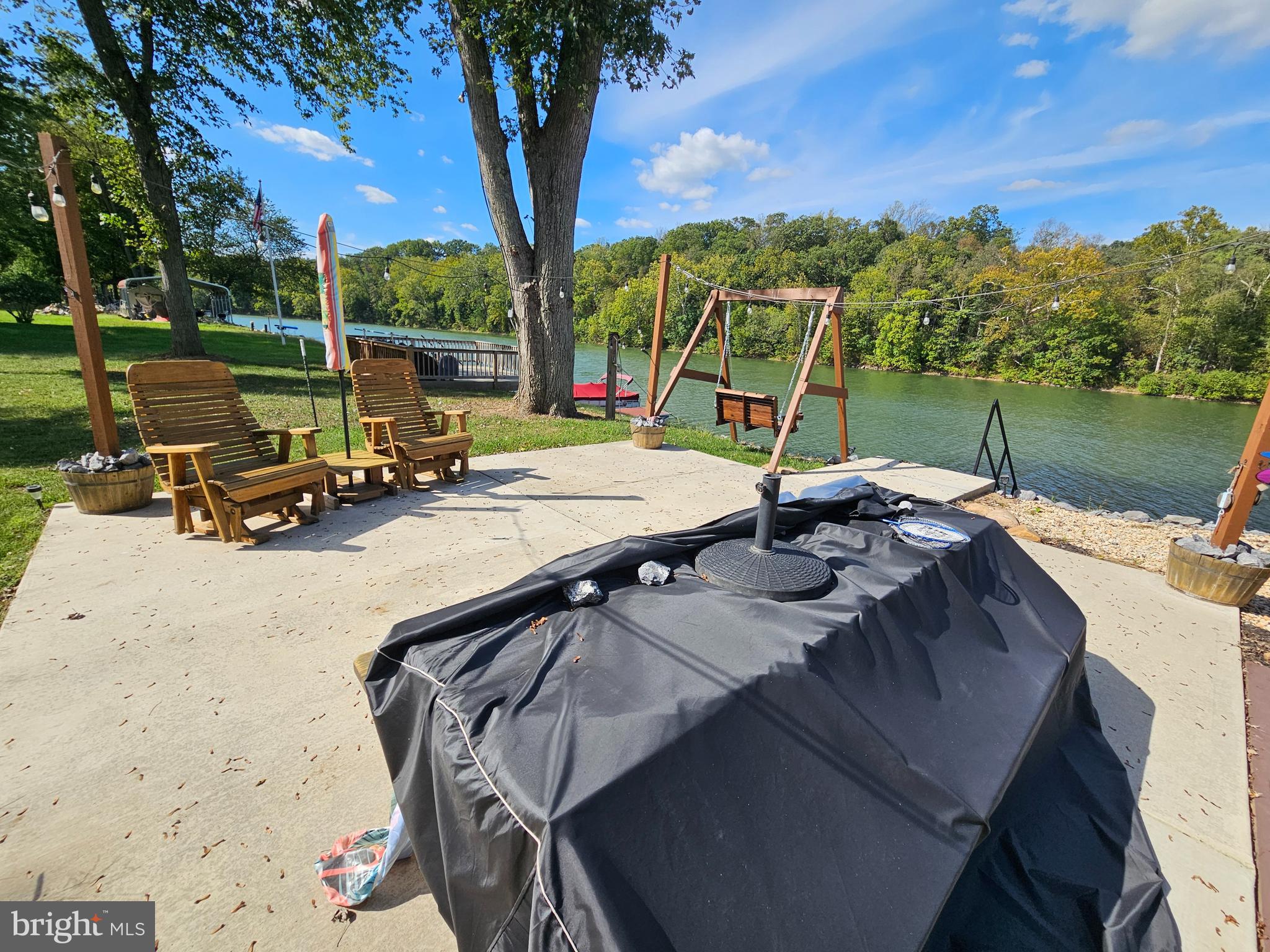 56 Boo Boo Boulevard Falling Waters, WV 25419 - Photo 4 of 48 a view of a patio with a table chairs and a fire pit