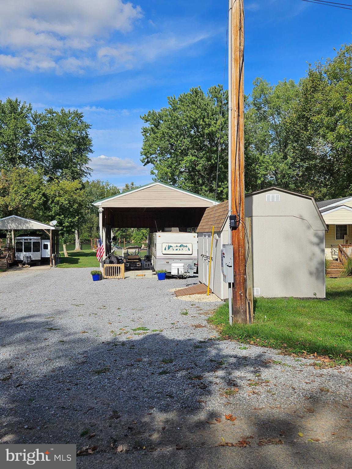 56 Boo Boo Boulevard Falling Waters, WV 25419 - Photo 7 of 48 a view of a patio with a table and chairs under an umbrella