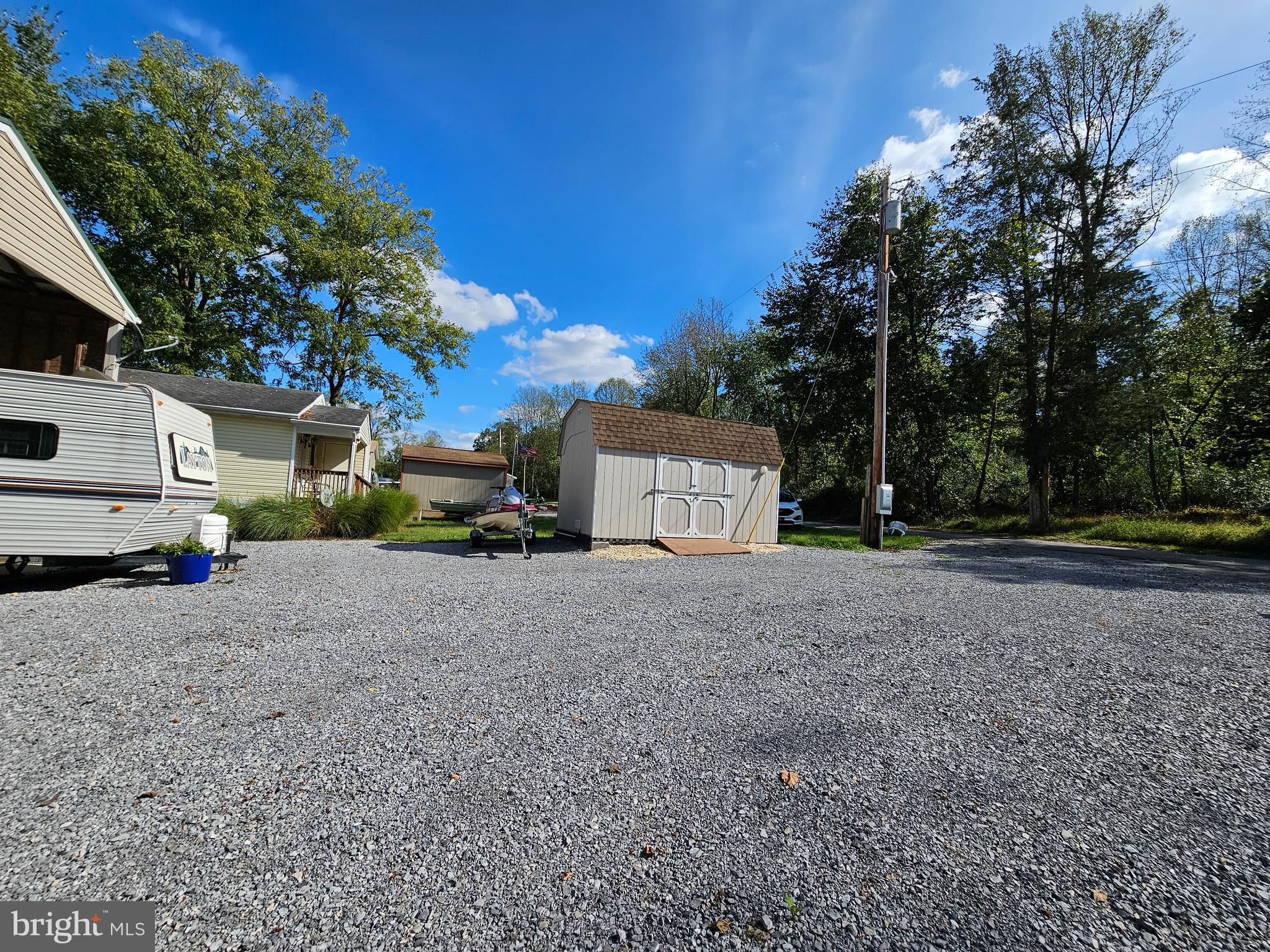 56 Boo Boo Boulevard Falling Waters, WV 25419 - Photo 9 of 48 a house with trees in front of it