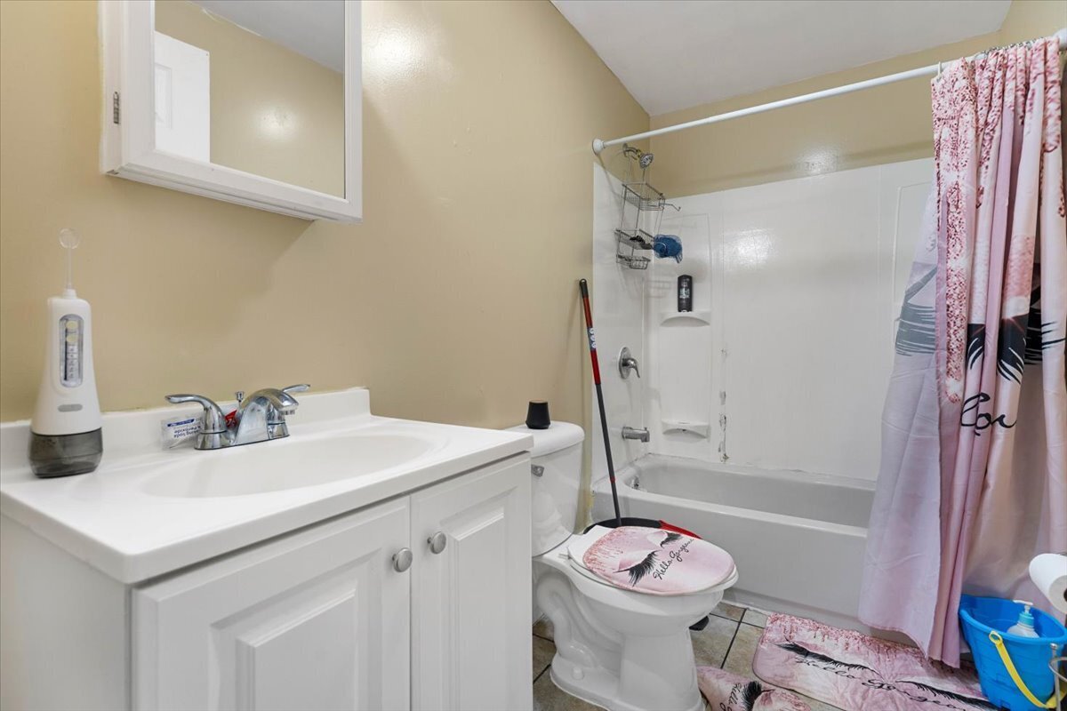 205 Smith Street Bridgeport, CT 06607 - Photo 13 of 28 a bathroom with a sink vanity tub and toilet