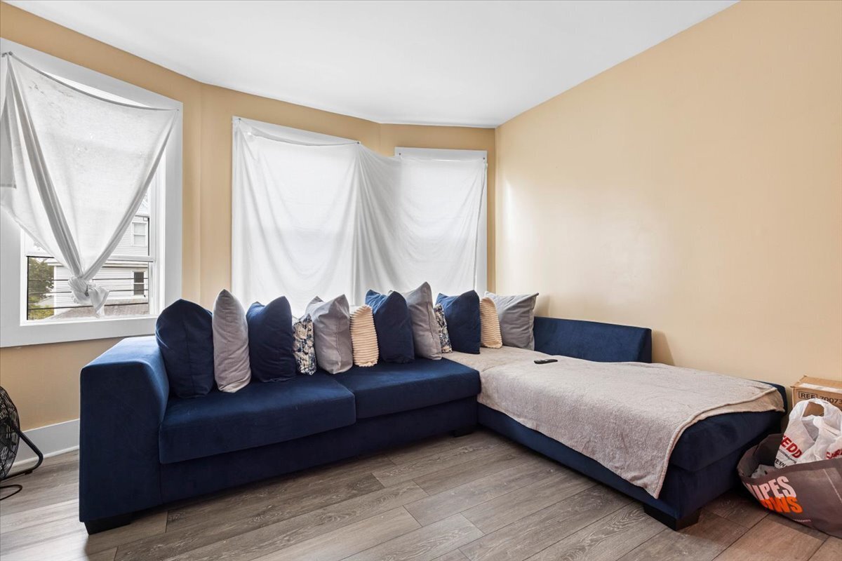 205 Smith Street Bridgeport, CT 06607 - Photo 16 of 28 a bedroom with a bed and a couch next to a window