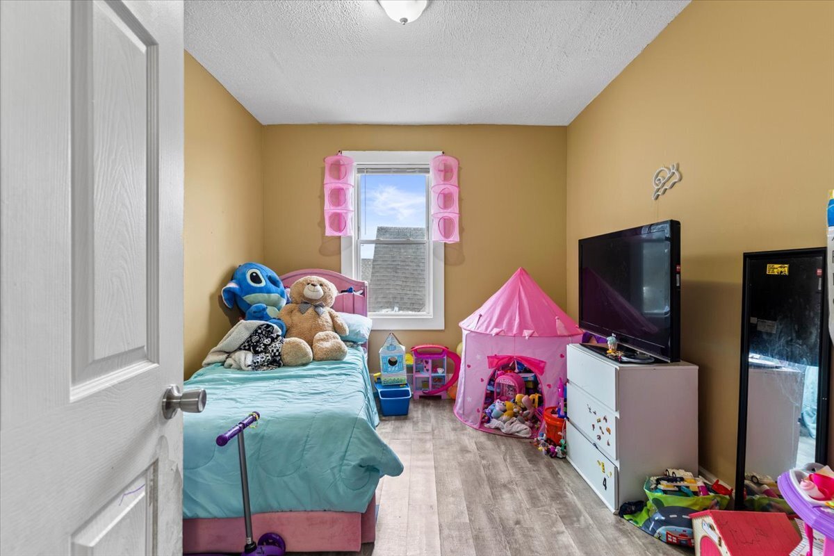 205 Smith Street Bridgeport, CT 06607 - Photo 20 of 28 a living room with furniture and a flat screen tv