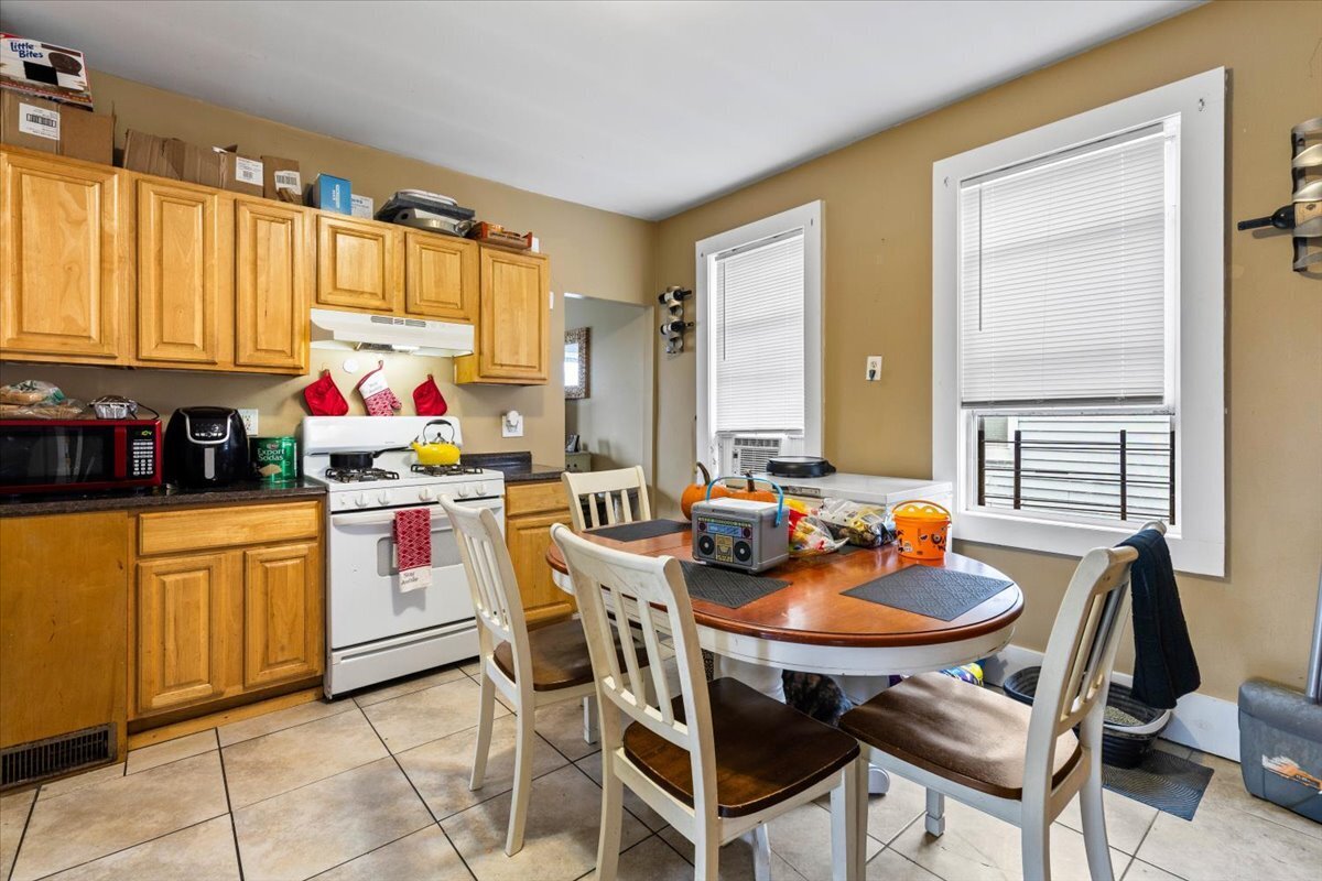 205 Smith Street Bridgeport, CT 06607 - Photo 21 of 28 a view of a dining room with furniture and a window
