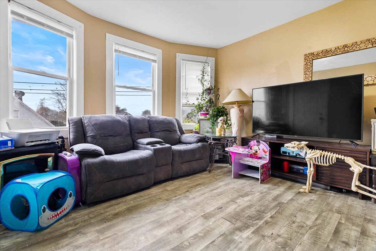 205 Smith Street Bridgeport, CT 06607 - Photo 23 of 28 a living room with furniture and a flat screen tv