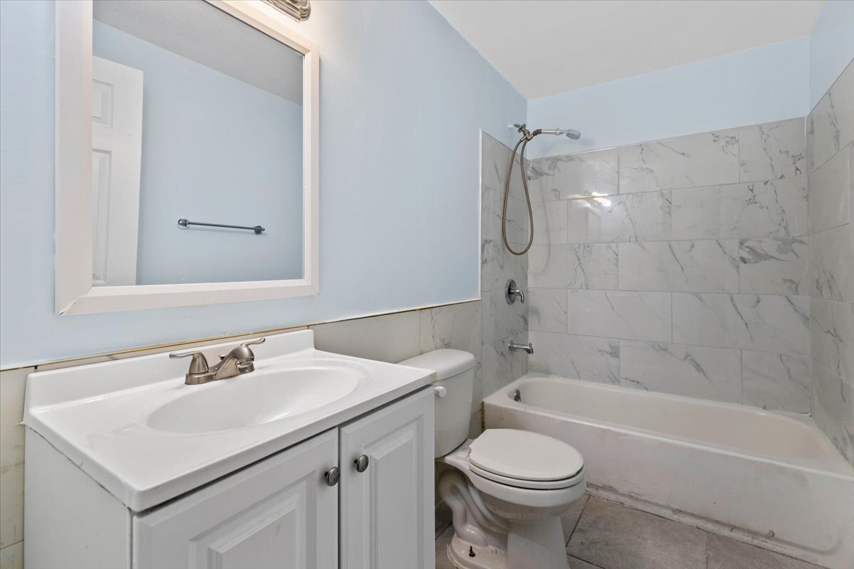 205 Smith Street Bridgeport, CT 06607 - Photo 4 of 28 a bathroom with a sink toilet vanity and shower